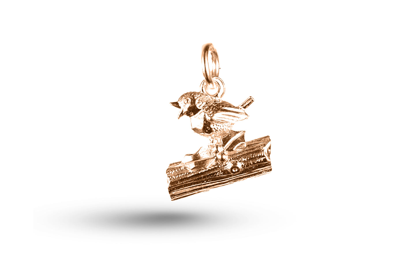 Rose gold Robin on Log Christmas charm.