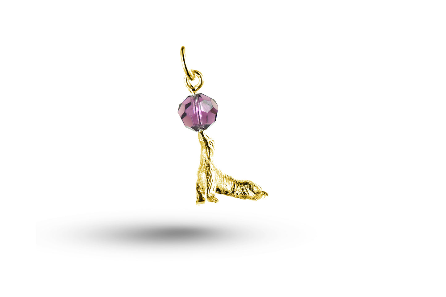 Yellow gold Sealion and Stone charm.