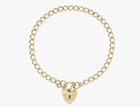 Luxury yellow gold curb charm bracelet with heart shaped padlock.